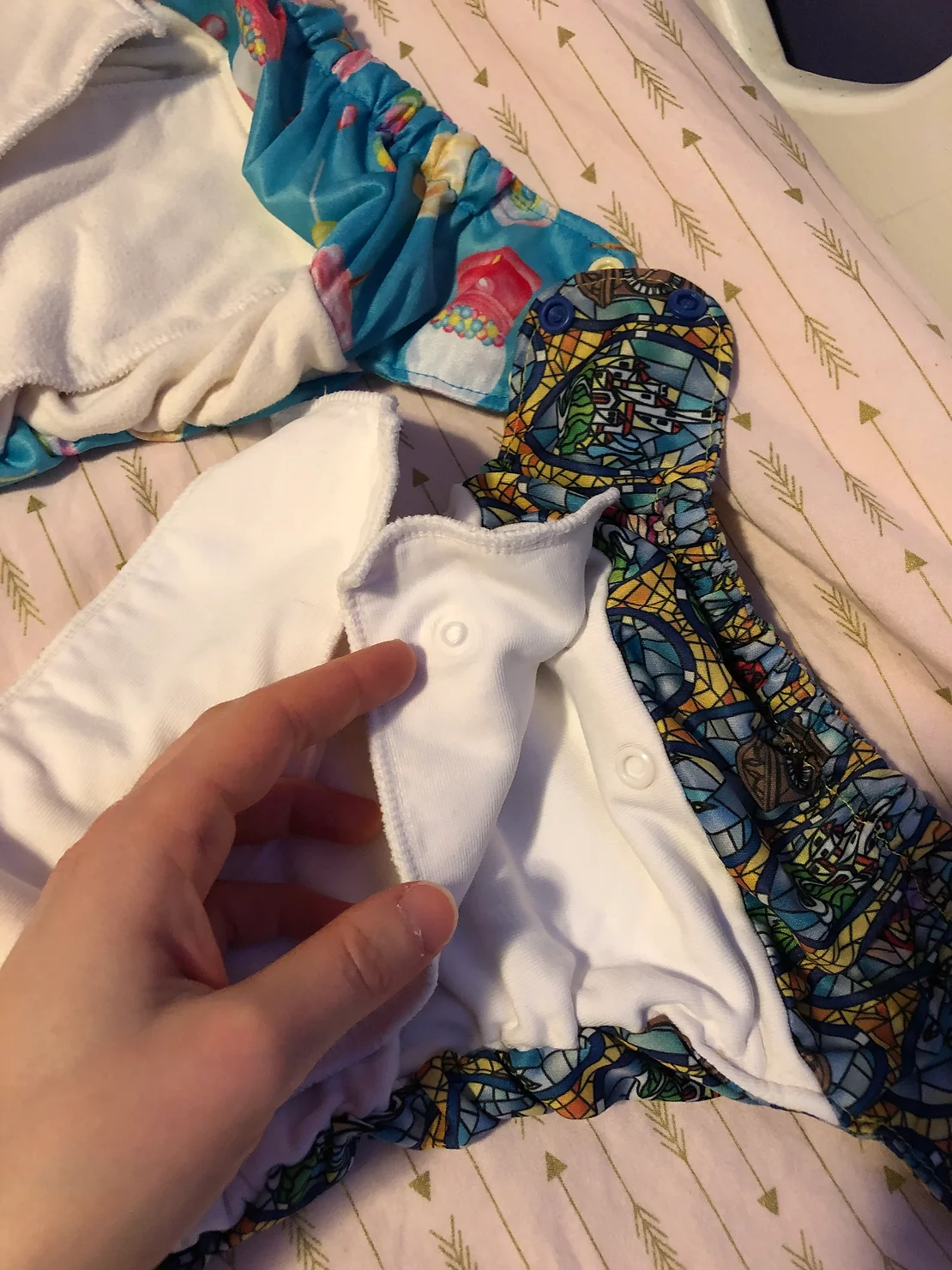 one diaper insert is sewn in and can be folded, the other diaper insert snaps in