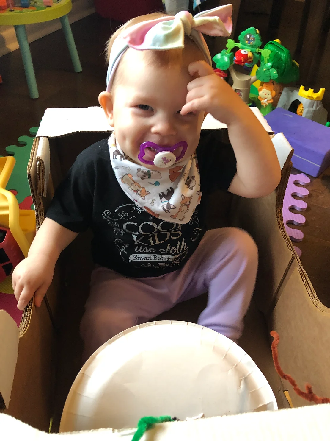 toddler sitting in cardboard box